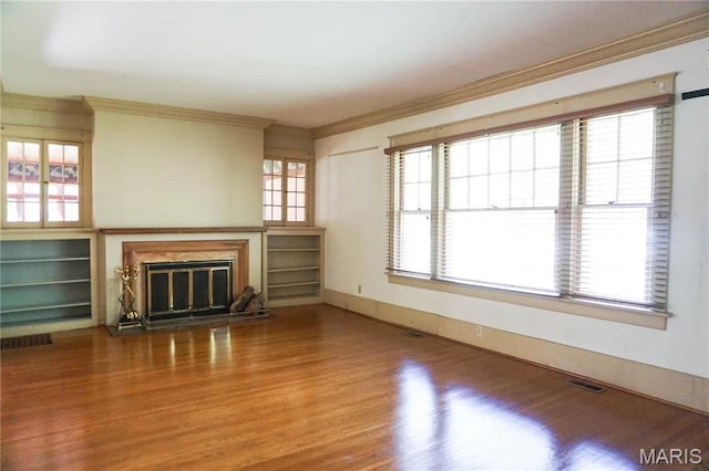 301 S Meramec St, St James, MO 65559 - unfurnished living room with ornamental molding, wood finished floors, and a glass covered fireplace