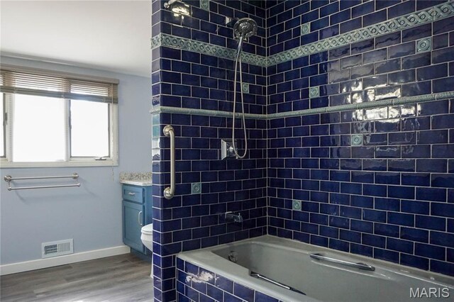 301 S Meramec St, St James, MO 65559 - bathroom with wood finished floors, tiled shower / bath combo, and vanity