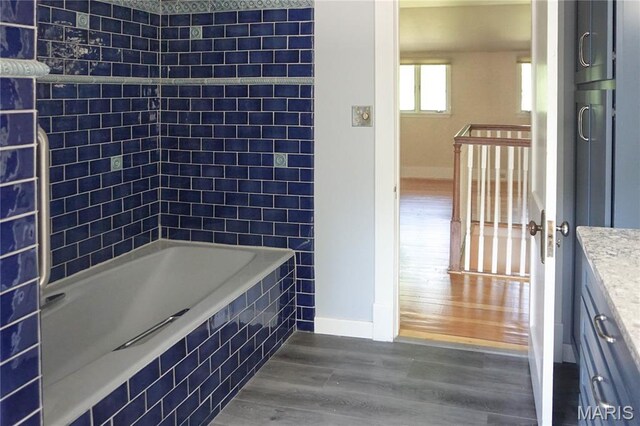 301 S Meramec St, St James, MO 65559 - full bath featuring wood finished floors, vanity, and tiled shower / bath combo