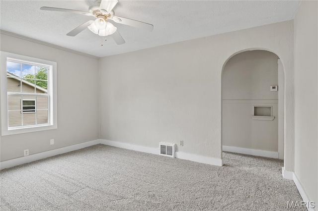 233 Oconnell St, Cape Girardeau, MO 63701 - empty room featuring carpet flooring, arched walkways, a textured ceiling, a ceiling fan, and baseboards