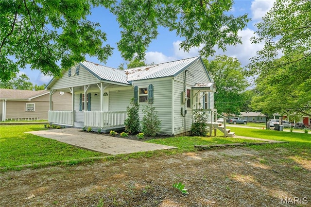 233 Oconnell St, Cape Girardeau, MO 63701 - view of front of house with covered porch, a front yard, and metal roof
