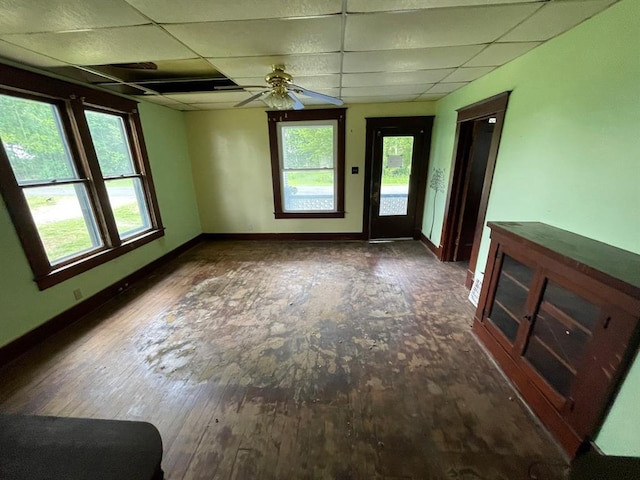 20621 County Highway 22, Hoyleton, IL 62803 - unfurnished room with a drop ceiling, healthy amount of natural light, baseboards, a ceiling fan, and wood-type flooring