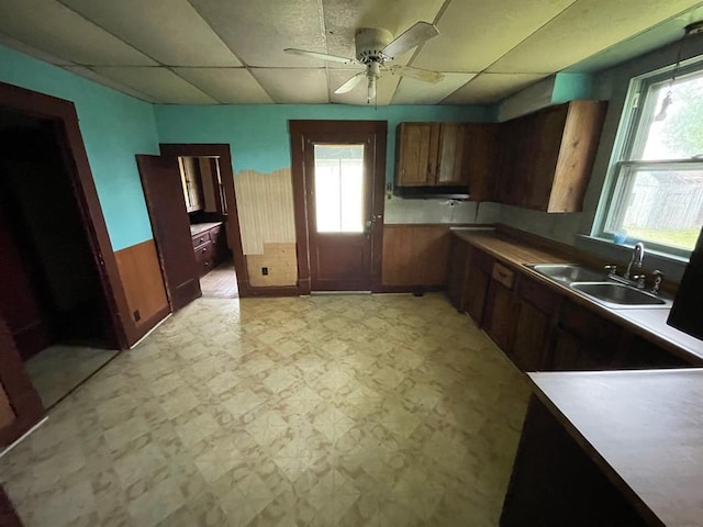 20621 County Highway 22, Hoyleton, IL 62803 - kitchen with light floors, a sink, a paneled ceiling, a ceiling fan, and brown cabinets