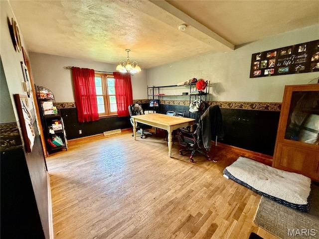 905 Dewitt St, Hannibal, MO 63401 - office area with a chandelier, wood finished floors, a baseboard heating unit, and a textured ceiling