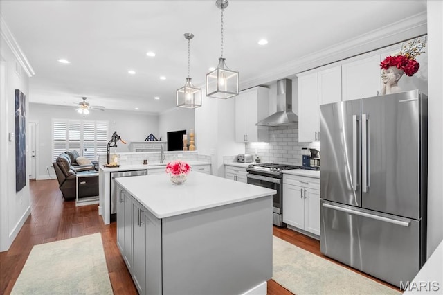 7723 Dale Ave, Richmond Heights, MO 63117 - kitchen featuring stainless steel appliances, wall chimney range hood, open floor plan, light countertops, and a center island