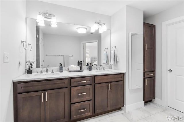 7723 Dale Ave, Richmond Heights, MO 63117 - bathroom featuring double vanity, marble finish floors, and baseboards