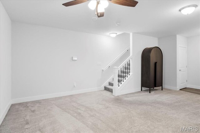 7723 Dale Ave, Richmond Heights, MO 63117 - unfurnished living room with carpet flooring, a ceiling fan, baseboards, and stairs