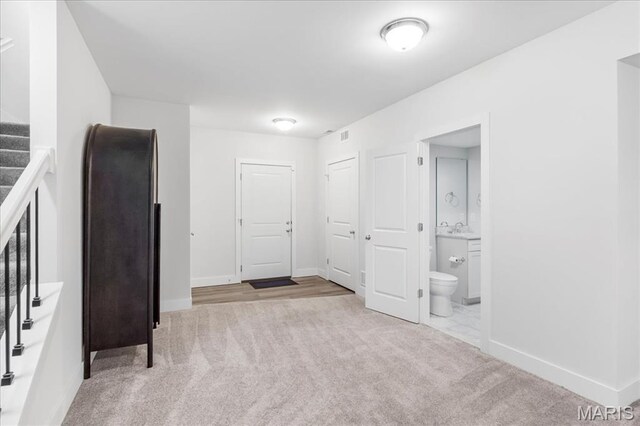 7723 Dale Ave, Richmond Heights, MO 63117 - carpeted empty room featuring stairs, baseboards, and a sink