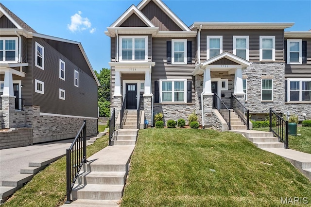 7723 Dale Ave, Richmond Heights, MO 63117 - view of front of property with board and batten siding, stone siding, and a front lawn