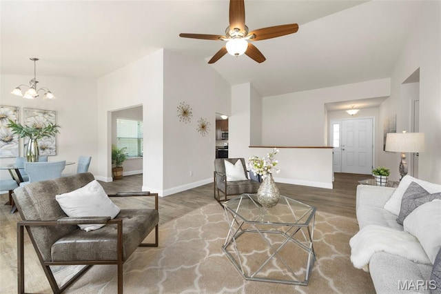 119 Hidden Bluffs Dr, Lake St Louis, MO 63367 - living area with wood finished floors, a chandelier, high vaulted ceiling, and a ceiling fan