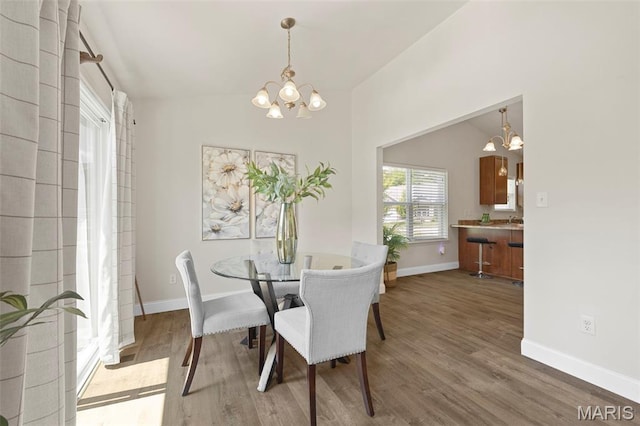 119 Hidden Bluffs Dr, Lake St Louis, MO 63367 - dining space with a chandelier and wood finished floors
