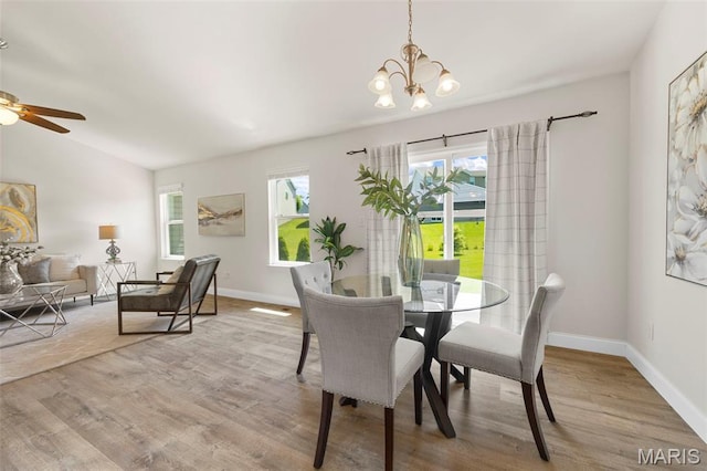 119 Hidden Bluffs Dr, Lake St Louis, MO 63367 - dining space featuring a chandelier, wood finished floors, a ceiling fan, and lofted ceiling