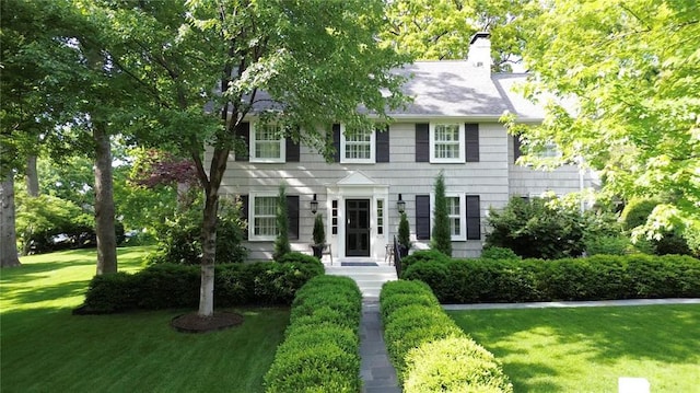 431 Somerset Ave, Webster Groves, MO 63119 - colonial-style house featuring a front lawn and a chimney