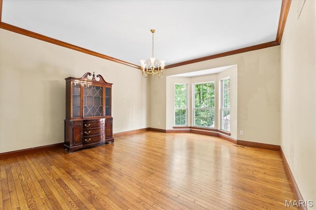 1519 Scofield Valley Ln, Wildwood, MO 63038 - spare room featuring wood-type flooring, a chandelier, and crown molding