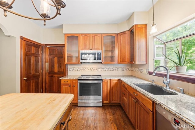 1519 Scofield Valley Ln, Wildwood, MO 63038 - kitchen with appliances with stainless steel finishes, plenty of natural light, and light stone countertops