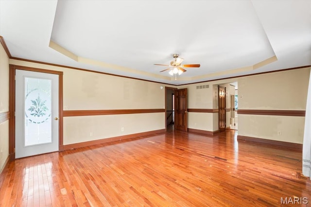 1519 Scofield Valley Ln, Wildwood, MO 63038 - spare room featuring a raised ceiling, hardwood / wood-style flooring, ceiling fan, and ornamental molding
