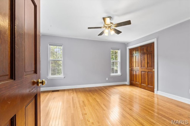 1519 Scofield Valley Ln, Wildwood, MO 63038 - unfurnished bedroom with multiple windows, light wood-type flooring, and ceiling fan