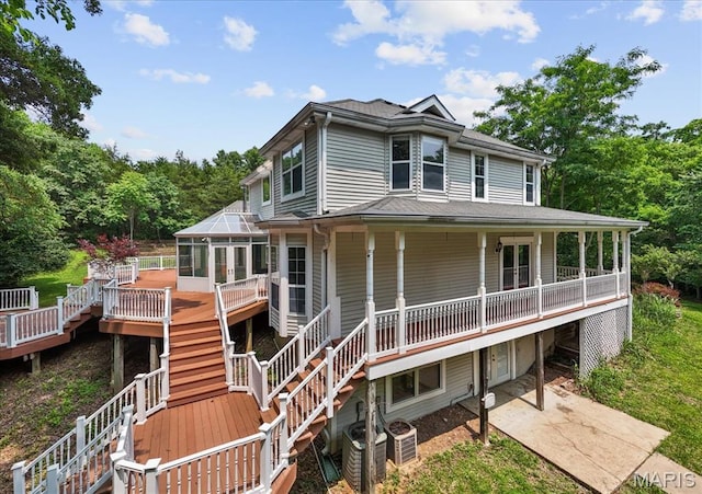 1519 Scofield Valley Ln, Wildwood, MO 63038 - view of front facade featuring a sunroom, stairway, a wooden deck, and a patio