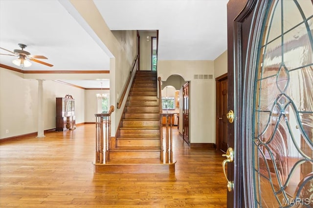 1519 Scofield Valley Ln, Wildwood, MO 63038 - entryway featuring a ceiling fan, stairway, wood finished floors, and arched walkways