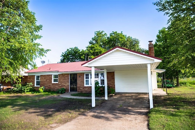 216 Patty Lynn Dr, Kennett, MO 63857 - ranch-style home featuring brick siding, concrete driveway, a chimney, and a front lawn