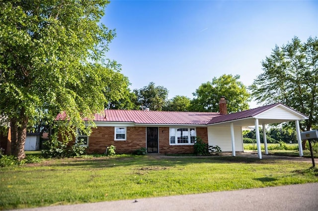 216 Patty Lynn Dr, Kennett, MO 63857 - ranch-style house featuring a front lawn, a chimney, metal roof, and a carport