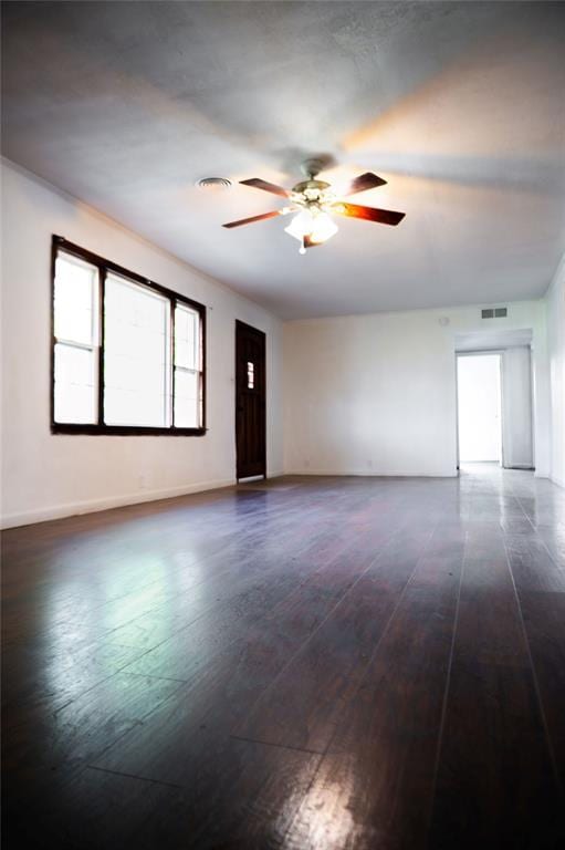 216 Patty Lynn Dr, Kennett, MO 63857 - empty room featuring a ceiling fan, dark wood-style floors, and baseboards