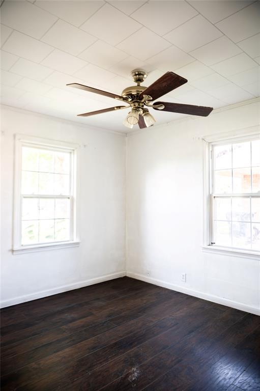 216 Patty Lynn Dr, Kennett, MO 63857 - spare room featuring dark wood-style flooring, ceiling fan, and baseboards