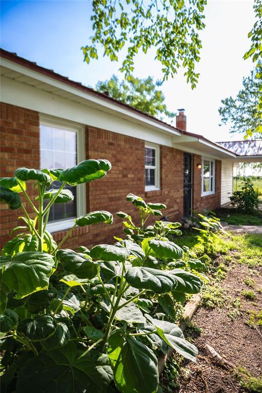 216 Patty Lynn Dr, Kennett, MO 63857 - view of front of house with brick siding and a chimney