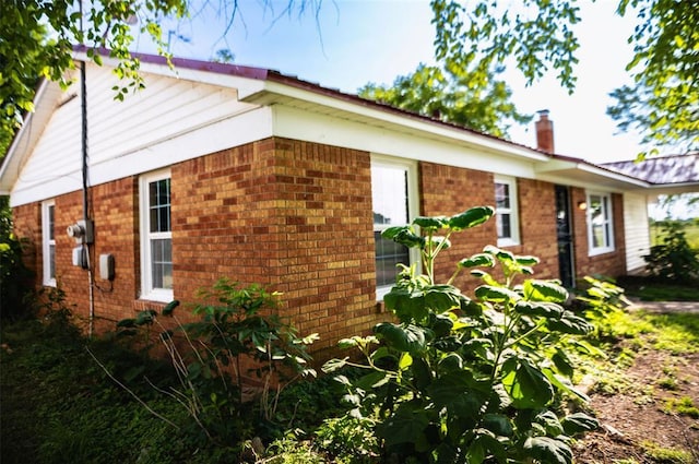 216 Patty Lynn Dr, Kennett, MO 63857 - view of home's exterior featuring brick siding and a chimney