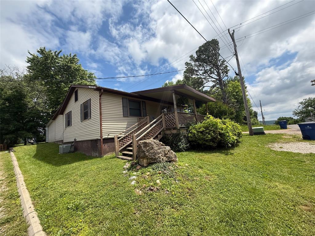 305 Central Ave, Marble Hill, MO 63764 - view of front of house with a front yard, stairway, and covered porch