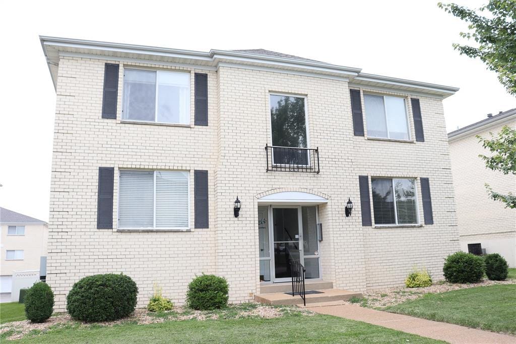 12544 Chardin Pl Unit 2, Saint Louis, MO 63128 - view of front facade featuring brick siding and a front lawn