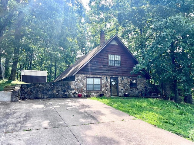 10492 County Road 605, Dexter, MO 63841 - view of front of property with stone siding, a chimney, and a front lawn