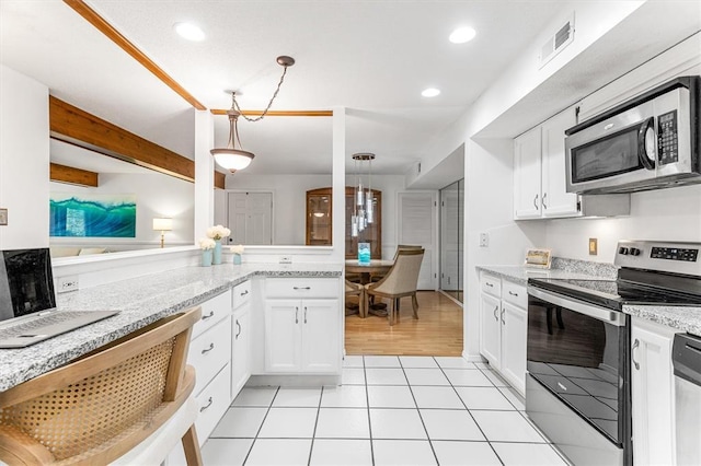 15017 Baxter Vlg Unit B, Chesterfield, MO 63017 - kitchen with appliances with stainless steel finishes, white cabinetry, light stone countertops, hanging light fixtures, and recessed lighting