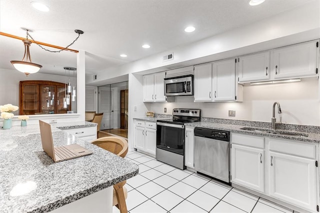 15017 Baxter Vlg Unit B, Chesterfield, MO 63017 - kitchen featuring appliances with stainless steel finishes, a sink, white cabinetry, and recessed lighting