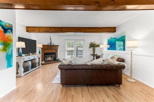15017 Baxter Vlg Unit B, Chesterfield, MO 63017 - living room with light wood finished floors, a glass covered fireplace, beamed ceiling, and baseboards