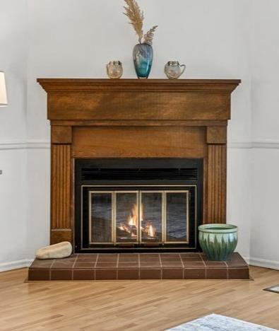15017 Baxter Vlg Unit B, Chesterfield, MO 63017 - detailed view of a tile fireplace, wood finished floors, and baseboards