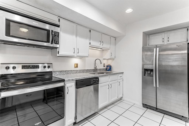 15017 Baxter Vlg Unit B, Chesterfield, MO 63017 - kitchen with stainless steel appliances, a sink, white cabinetry, light tile patterned floors, and recessed lighting