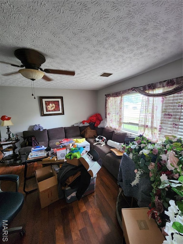 1520 Flicker Dr, Florissant, MO 63031 - living area with wood finished floors, a ceiling fan, and a textured ceiling