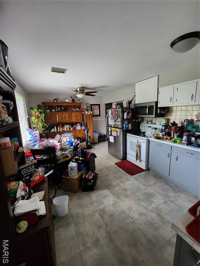 1520 Flicker Dr, Florissant, MO 63031 - kitchen with stainless steel appliances, white cabinetry, and a ceiling fan