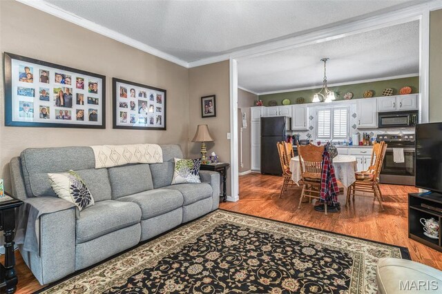 406 N Division St, Bonne Terre, MO 63628 - living room with light wood-style floors, crown molding, a textured ceiling, and baseboards