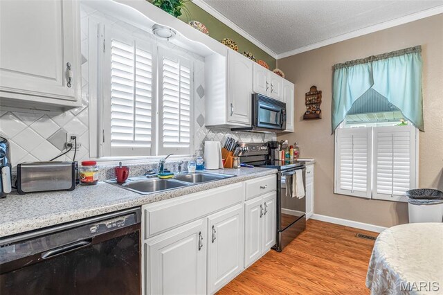 406 N Division St, Bonne Terre, MO 63628 - kitchen with black appliances, a sink, crown molding, white cabinetry, and light countertops