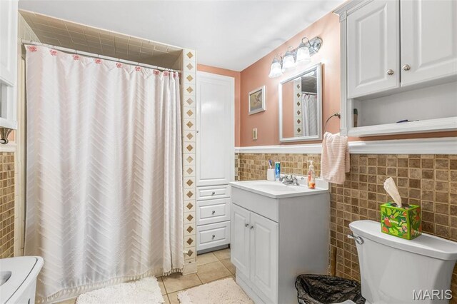 406 N Division St, Bonne Terre, MO 63628 - bathroom with toilet, vanity, tile walls, tile patterned flooring, and a shower with curtain