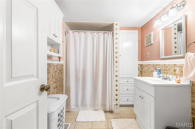 406 N Division St, Bonne Terre, MO 63628 - full bathroom with tile walls, vanity, tile patterned floors, a shower with curtain, and a wainscoted wall