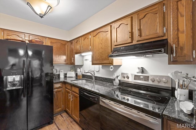 1001 Windstream Dr Unit 32, Saint Peters, MO 63376 - kitchen featuring black appliances, under cabinet range hood, a sink, and brown cabinets