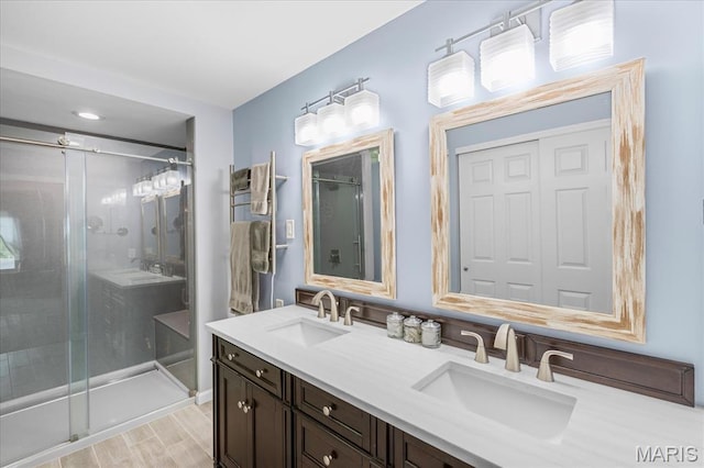1001 Windstream Dr Unit 32, Saint Peters, MO 63376 - full bathroom with double vanity, a shower stall, and wood finished floors