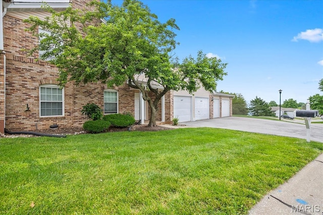 1001 Windstream Dr Unit 32, Saint Peters, MO 63376 - obstructed view of property featuring driveway, a front yard, and brick siding