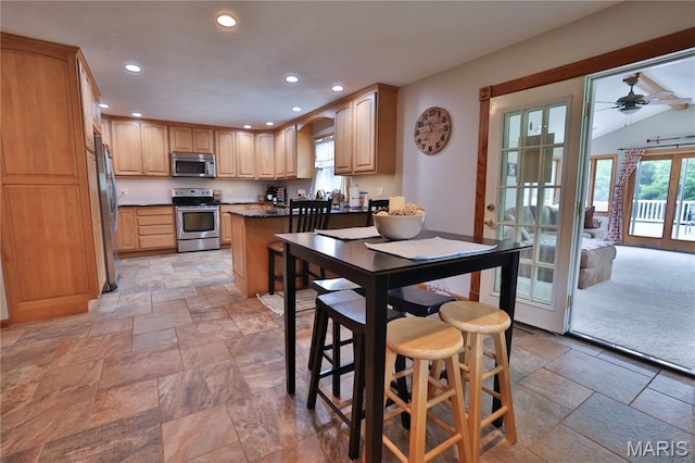 306 Lakewood Dr, Hillsboro, IL 62049 - kitchen with stainless steel appliances, stone tile floors, recessed lighting, ceiling fan, and a peninsula