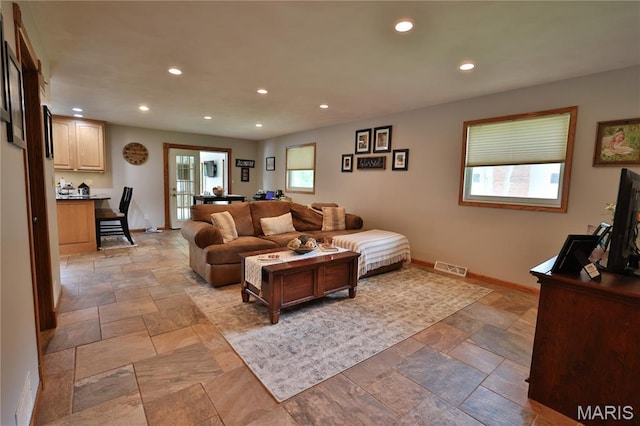 306 Lakewood Dr, Hillsboro, IL 62049 - living room featuring stone tile floors, baseboards, and recessed lighting