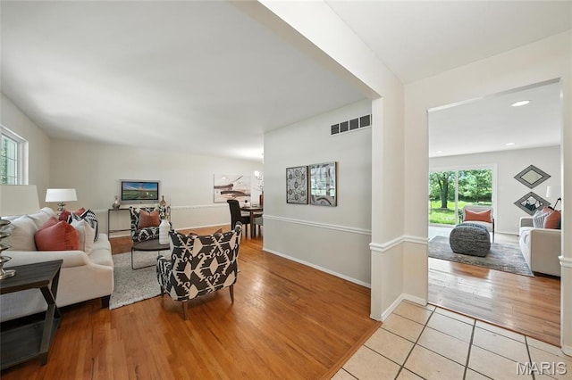 1214 Iron Warrior Ln, Ballwin, MO 63011 - living area with healthy amount of natural light and wood finished floors