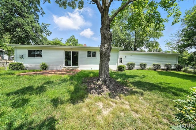 1214 Iron Warrior Ln, Ballwin, MO 63011 - back of house featuring a lawn, a chimney, and entry steps